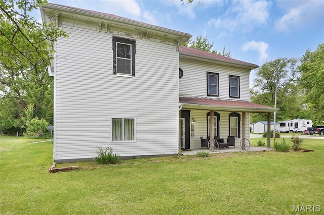 401 S Main St, New Florence, MO 63363 - rear view of property featuring a yard and covered porch
