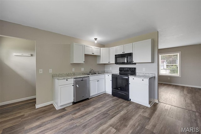 1448 Kathleen Dr, Wentzville, MO 63385 - kitchen with black appliances, dark wood finished floors, white cabinetry, and light stone countertops