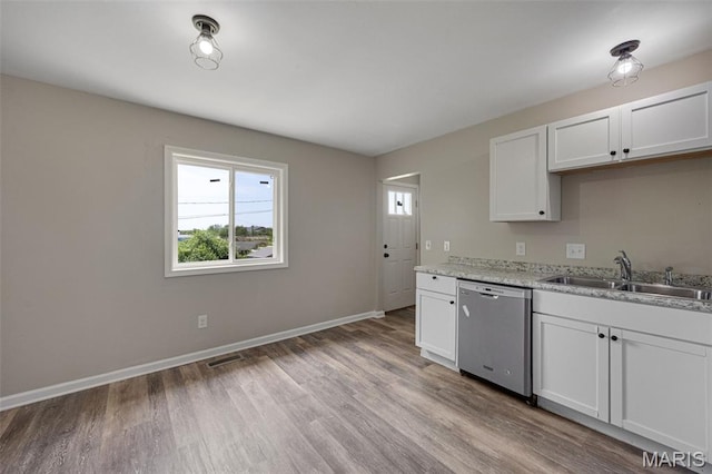 1448 Kathleen Dr, Wentzville, MO 63385 - kitchen featuring dishwasher, plenty of natural light, light wood-style flooring, and white cabinets