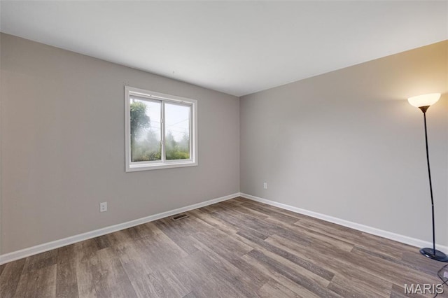 1448 Kathleen Dr, Wentzville, MO 63385 - spare room featuring wood finished floors and baseboards