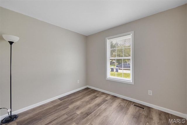 1448 Kathleen Dr, Wentzville, MO 63385 - empty room with wood finished floors and baseboards