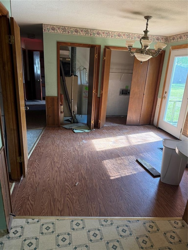 319 Bronaugh, Morley, MO 63767 - unfurnished dining area with a textured ceiling, a chandelier, and tile patterned floors