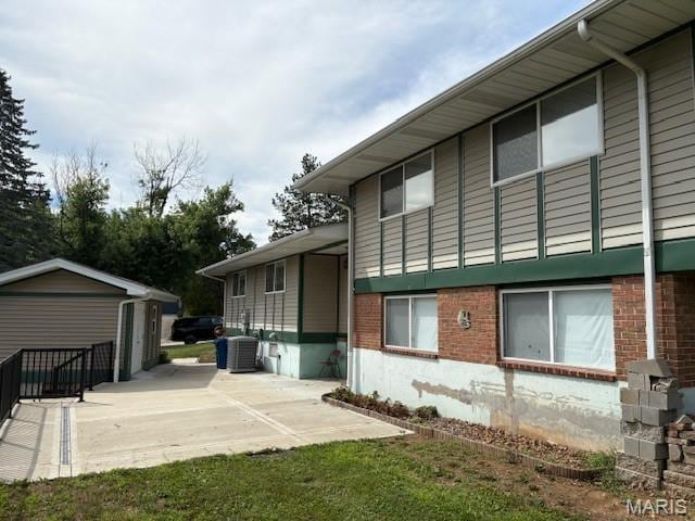 678 Henry Ave, Manchester, MO 63011 - view of side of home featuring brick siding and a patio area