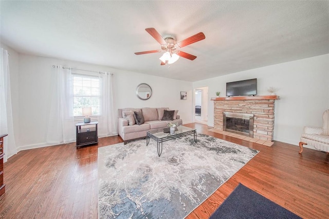 1707 S Mcarthur Ave, Salem, MO 65560 - living area with a ceiling fan, wood finished floors, and a stone fireplace
