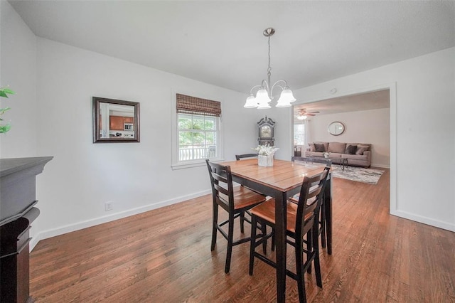 1707 S Mcarthur Ave, Salem, MO 65560 - dining area featuring a chandelier, wood finished floors, and baseboards