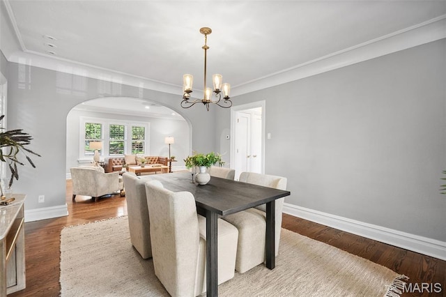 436 W Point Ct, Saint Louis, MO 63130 - dining area with arched walkways, ornamental molding, a chandelier, and wood finished floors