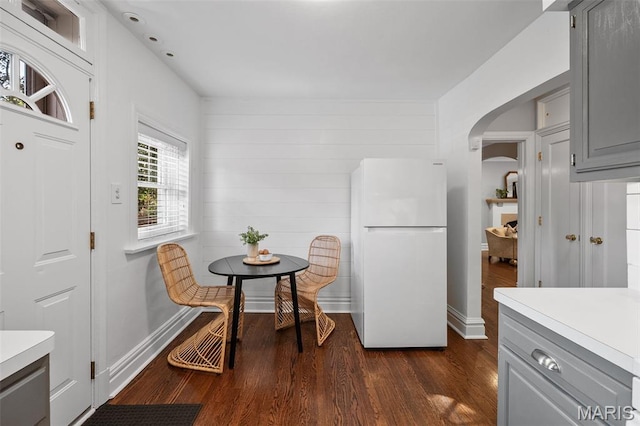 436 W Point Ct, Saint Louis, MO 63130 - kitchen featuring freestanding refrigerator, gray cabinetry, arched walkways, light countertops, and dark wood-type flooring