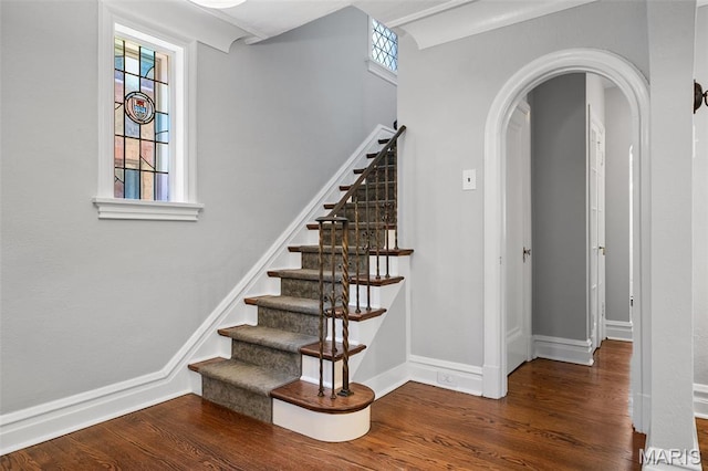 436 W Point Ct, Saint Louis, MO 63130 - stairway featuring arched walkways, wood finished floors, and plenty of natural light