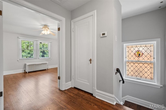 436 W Point Ct, Saint Louis, MO 63130 - hallway with radiator, an upstairs landing, and dark wood finished floors