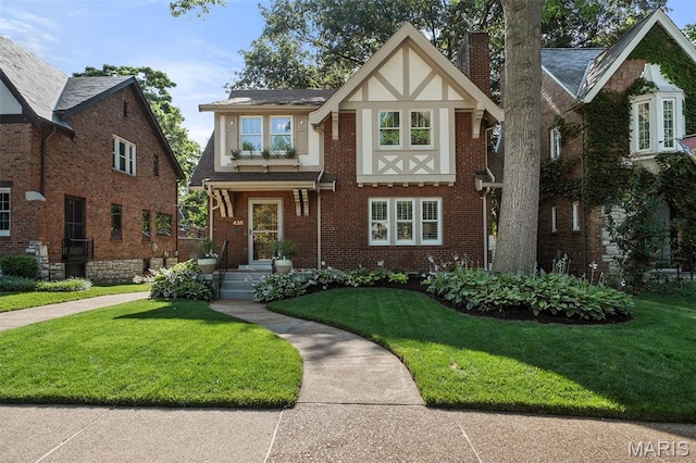 436 W Point Ct, Saint Louis, MO 63130 - english style home featuring a front lawn, brick siding, and a chimney