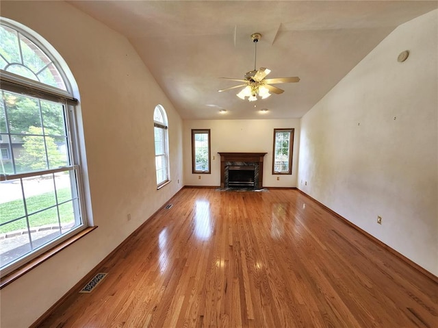103 Northview Dr, Collinsville, IL 62234 - unfurnished living room with vaulted ceiling, plenty of natural light, light wood finished floors, a ceiling fan, and a fireplace