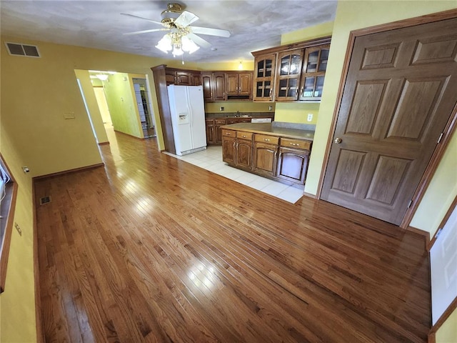 103 Northview Dr, Collinsville, IL 62234 - kitchen with white fridge with ice dispenser, light wood-style floors, ceiling fan, glass insert cabinets, and a sink