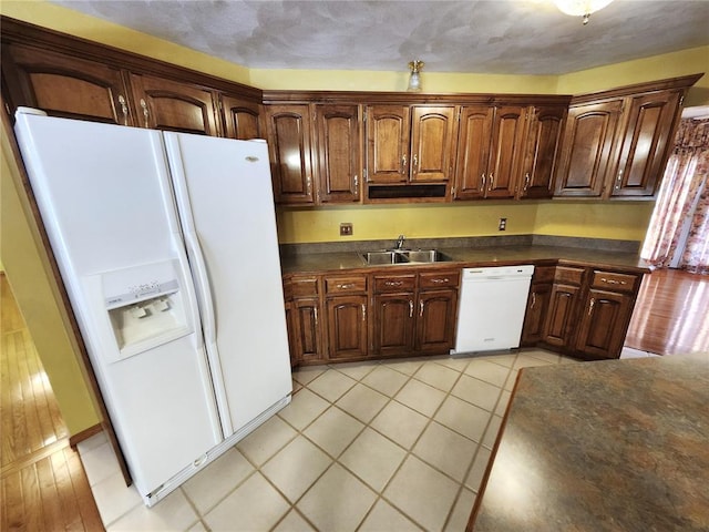 103 Northview Dr, Collinsville, IL 62234 - kitchen with white appliances, dark countertops, a sink, and light tile patterned floors