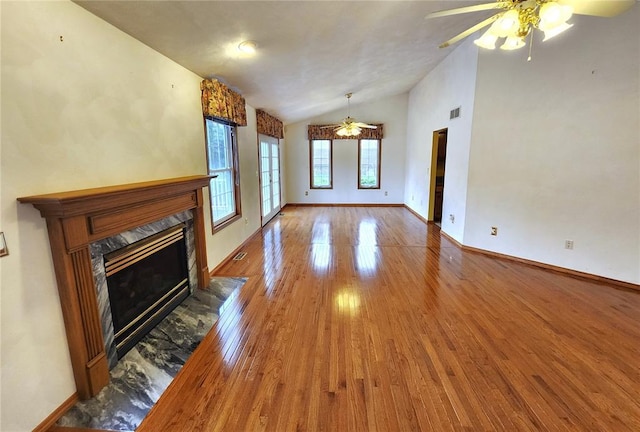 103 Northview Dr, Collinsville, IL 62234 - unfurnished living room with ceiling fan, vaulted ceiling, wood finished floors, a premium fireplace, and baseboards