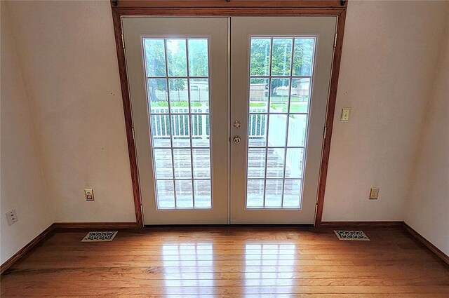 103 Northview Dr, Collinsville, IL 62234 - doorway featuring french doors, wood finished floors, and baseboards
