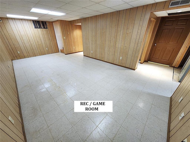 103 Northview Dr, Collinsville, IL 62234 - spare room with wood walls, light floors, and a drop ceiling