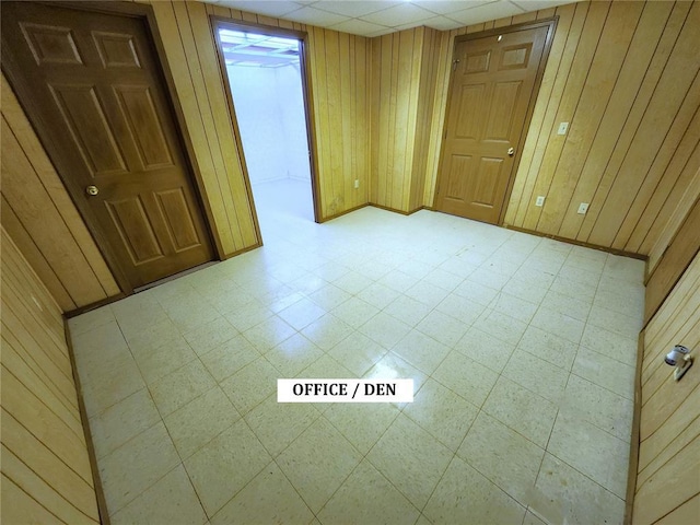 103 Northview Dr, Collinsville, IL 62234 - empty room featuring wood walls, tile patterned floors, and baseboards