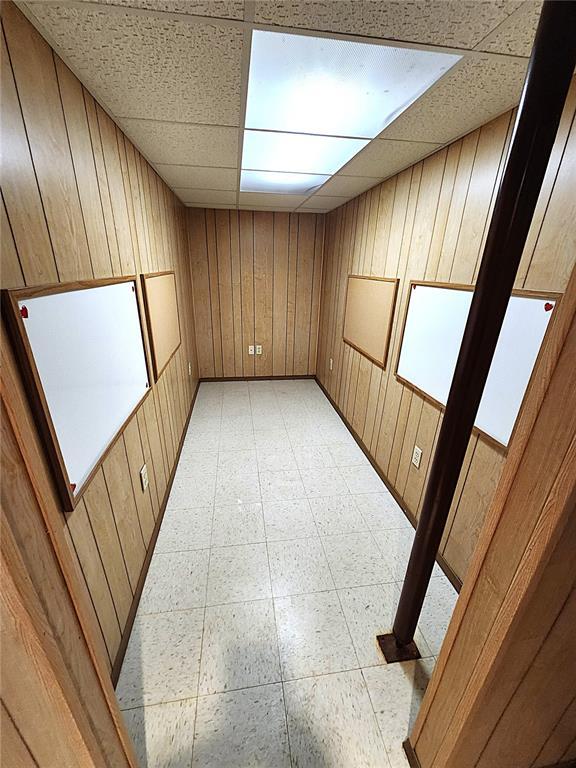 103 Northview Dr, Collinsville, IL 62234 - empty room featuring wooden walls, a paneled ceiling, and light flooring