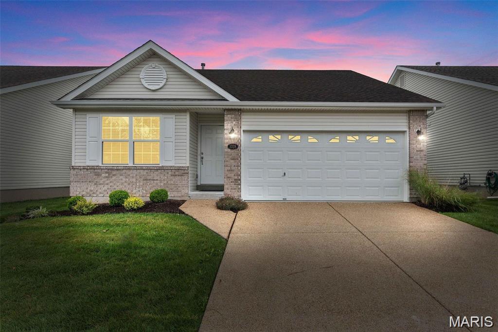 1028 Silo Bend Dr, Wentzville, MO 63385 - ranch-style home with brick siding, concrete driveway, a garage, and a front lawn