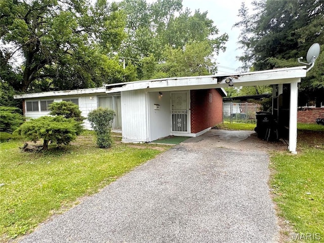 8406 January Ave, Berkeley, MO 63134 - view of front of property featuring asphalt driveway, a front yard, and a carport