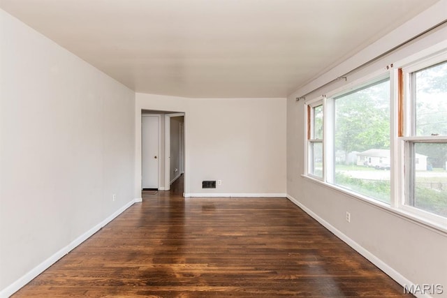 190 Anistasia Dr, Saint Louis, MO 63135 - empty room featuring healthy amount of natural light, dark wood finished floors, and baseboards