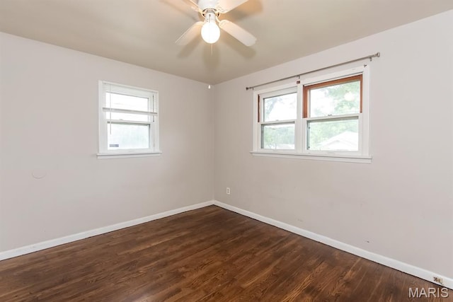 190 Anistasia Dr, Saint Louis, MO 63135 - spare room featuring baseboards, healthy amount of natural light, dark wood-type flooring, and a ceiling fan