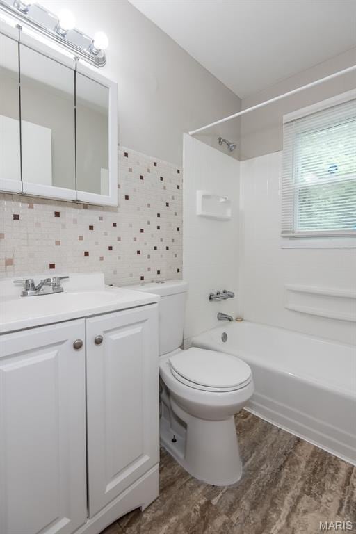 190 Anistasia Dr, Saint Louis, MO 63135 - bathroom featuring bathtub / shower combination, toilet, wood finished floors, backsplash, and vanity