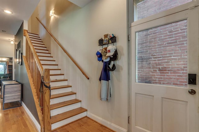 2628 Indiana Ave, Saint Louis, MO 63118 - stairway featuring wood finished floors, baseboards, and recessed lighting