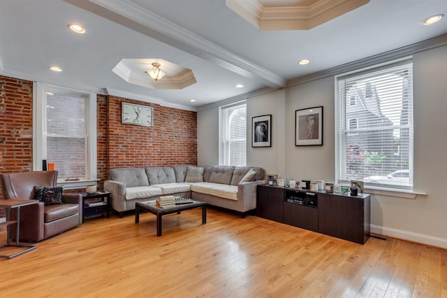 2628 Indiana Ave, Saint Louis, MO 63118 - living area with a raised ceiling, light wood-type flooring, crown molding, baseboards, and brick wall