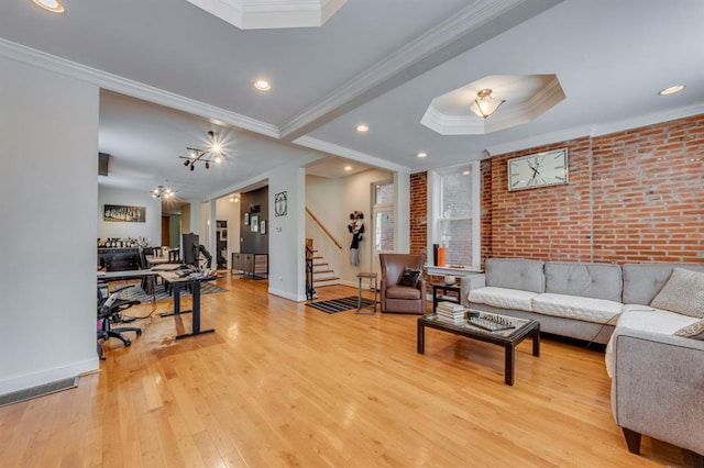 2628 Indiana Ave, Saint Louis, MO 63118 - living room with crown molding, stairway, hardwood / wood-style flooring, brick wall, and a tray ceiling
