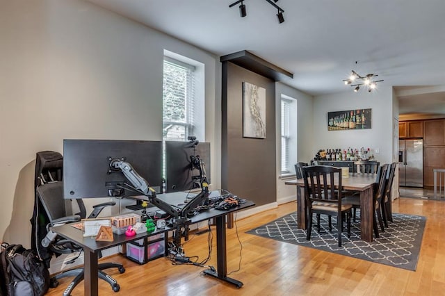 2628 Indiana Ave, Saint Louis, MO 63118 - dining area featuring light wood-style floors, an office area, and baseboards