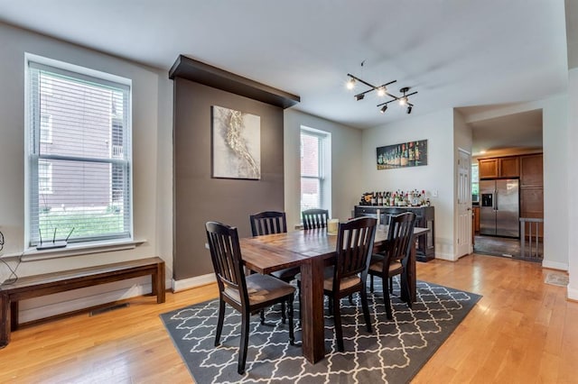 2628 Indiana Ave, Saint Louis, MO 63118 - dining room featuring light wood-style floors, a chandelier, and baseboards
