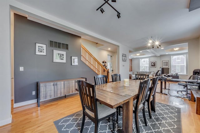 2628 Indiana Ave, Saint Louis, MO 63118 - dining space with wood finished floors, stairs, and baseboards