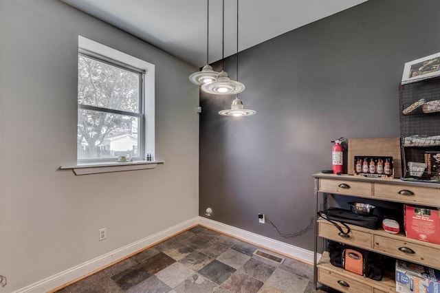 2628 Indiana Ave, Saint Louis, MO 63118 - dining area featuring baseboards and dark stone finish flooring
