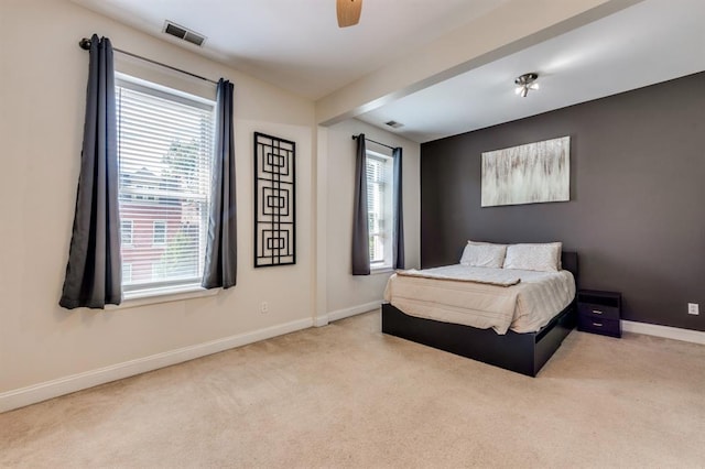 2628 Indiana Ave, Saint Louis, MO 63118 - carpeted bedroom with multiple windows, baseboards, and a ceiling fan
