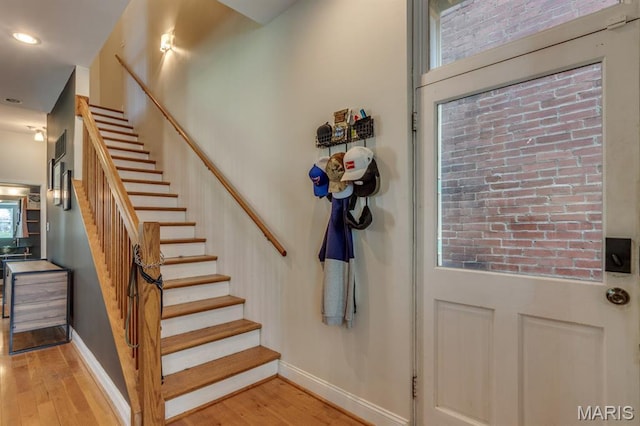 2628 Indiana Ave, Saint Louis, MO 63118 - stairway with wood finished floors, baseboards, and recessed lighting