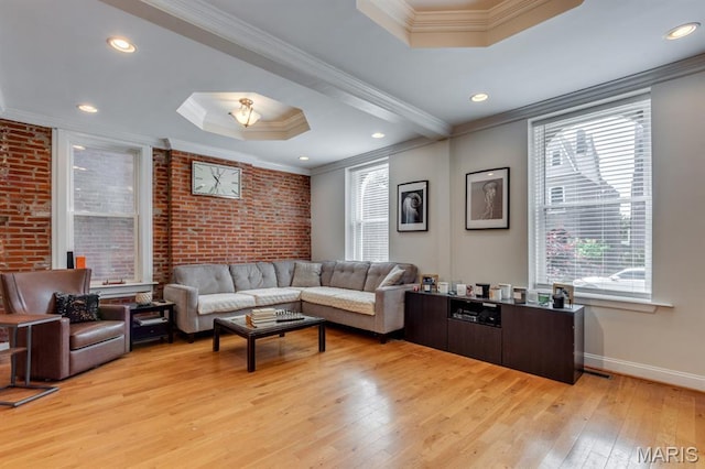 2628 Indiana Ave, Saint Louis, MO 63118 - living area with a raised ceiling, crown molding, light wood finished floors, baseboards, and brick wall