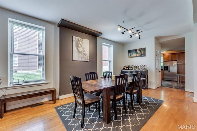 2628 Indiana Ave, Saint Louis, MO 63118 - dining space featuring light wood-style flooring, a chandelier, and baseboards