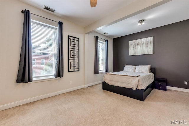 2628 Indiana Ave, Saint Louis, MO 63118 - carpeted bedroom featuring multiple windows, baseboards, and ceiling fan