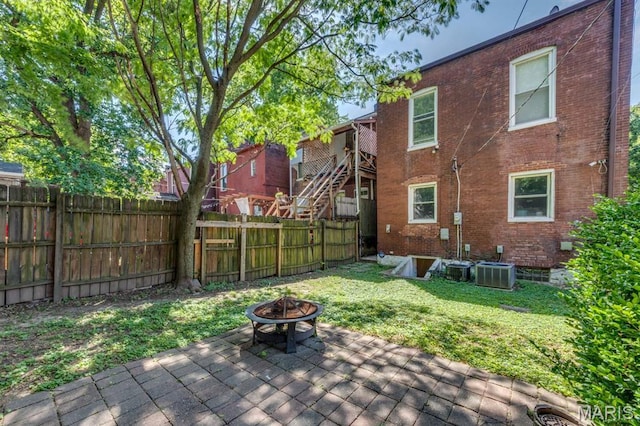 2628 Indiana Ave, Saint Louis, MO 63118 - wooden terrace with an outdoor fire pit, cooling unit, and a patio area