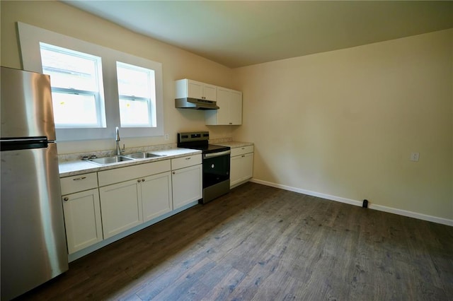 300 W Baker St, Gillespie, IL 62033 - kitchen with appliances with stainless steel finishes, a sink, under cabinet range hood, dark wood-style flooring, and white cabinets