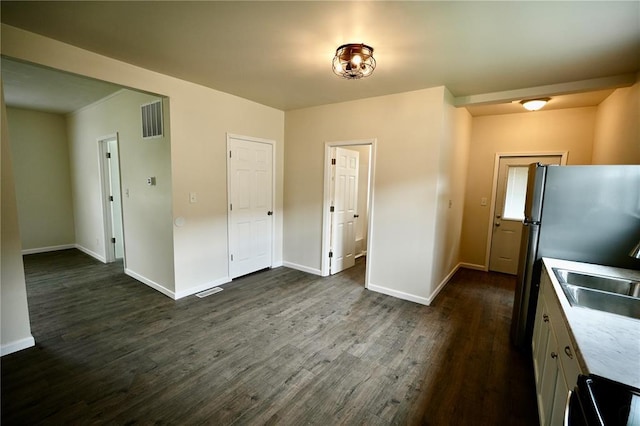 300 W Baker St, Gillespie, IL 62033 - kitchen featuring a sink, dark wood-type flooring, baseboards, stove, and light countertops