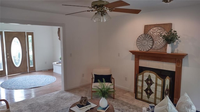 1059 Wolf Crk, Staunton, IL 62088 - living room featuring ceiling fan, baseboards, a tiled fireplace, and wood finished floors