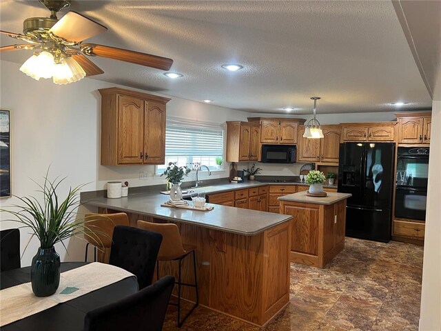 1059 Wolf Crk, Staunton, IL 62088 - kitchen featuring black appliances, a center island, brown cabinetry, a peninsula, and recessed lighting