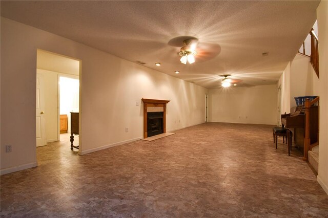 1059 Wolf Crk, Staunton, IL 62088 - unfurnished living room featuring a ceiling fan, a fireplace, tile patterned floors, baseboards, and a textured ceiling