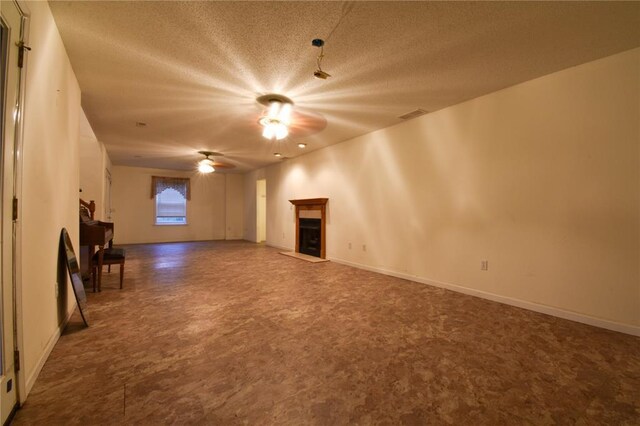 1059 Wolf Crk, Staunton, IL 62088 - unfurnished living room with ceiling fan, a fireplace, a textured ceiling, and baseboards