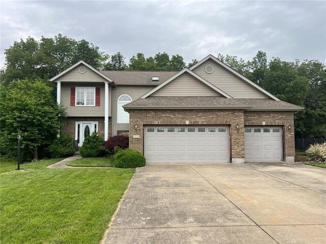 1059 Wolf Crk, Staunton, IL 62088 - view of front of house featuring concrete driveway, brick siding, a front lawn, and a garage
