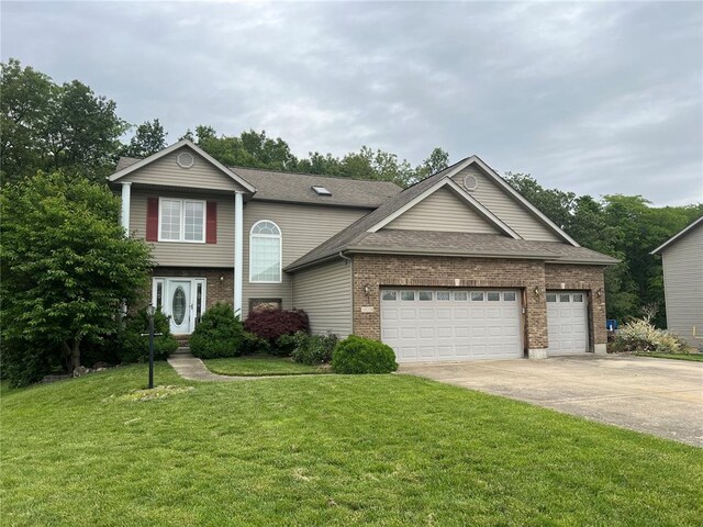 1059 Wolf Crk, Staunton, IL 62088 - traditional-style house featuring brick siding, driveway, a garage, a front lawn, and roof with shingles