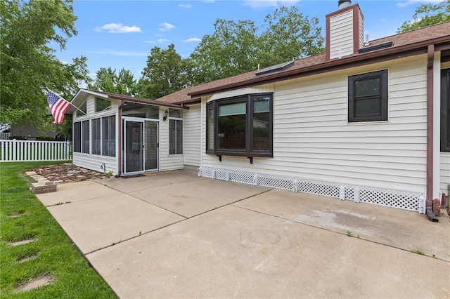 102 S Willow Grove Ct, Saint Peters, MO 63376 - back of house with a patio area, a sunroom, a chimney, and a shingled roof