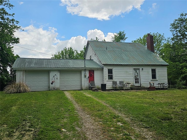 9119 Pearidge Rd, Baldwin, IL 62217 - back of house featuring dirt driveway, a chimney, a yard, a garage, and metal roof